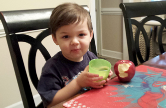A young boy eating an apple