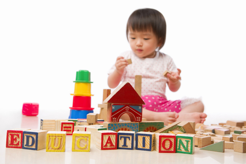 A baby plays with blocks